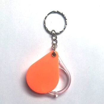 Folding keyholder with magnifying glass for special reading